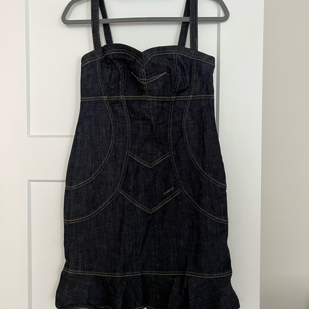 Denim mini dress w/ ruffle bottom by Bebe